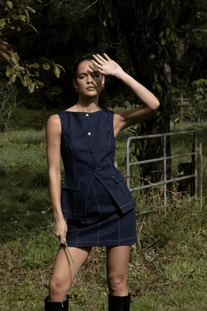 Good Vibes Top Indigo by Pasduchas – Trendy stretch denim with structured fit, gold snap studs, and mock pockets; perfect for chic, coordinated looks.