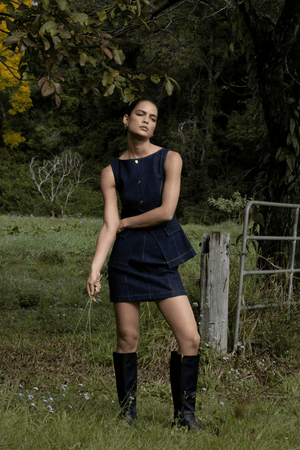 Good Vibes Top Indigo by Pasduchas – Trendy stretch denim with structured fit, gold snap studs, and mock pockets; perfect for chic, coordinated looks.