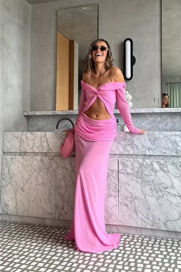 Emily Gown Candy Pink by Natalie Rolt – A trendy, ethereal georgette gown with off-shoulder draping and fluid bias cut, perfect for special occasions and statement-making moments.
