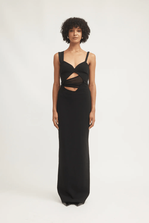 Madeleine Dress Black by Tojhà – A viral double-bonded crepe maxi with asymmetric straps, curved cut-out, and layered mesh, perfect for elegant evening events.
