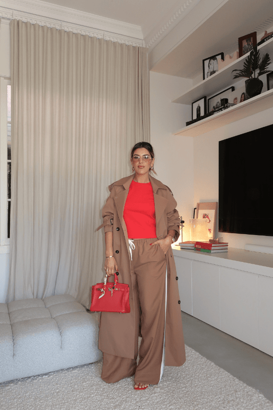 Trench Coat Tan by Sneaky Link – A timeless oversized coat in rich tan polyester, featuring classic details and subtle snake embroidery. Perfect for stylish transitional days.