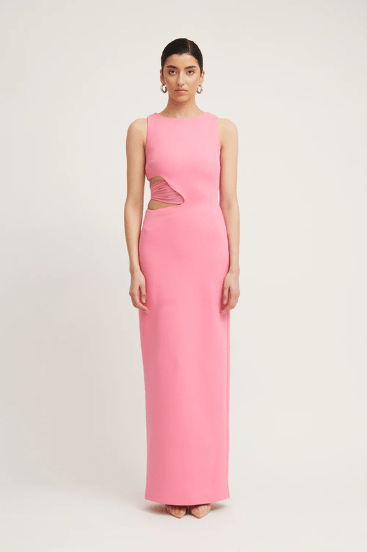 Valentina Dress Rouge Pink by Tojhà – A bold and sleek maxi with a boat neckline and unique waist cut-out, perfect for elegant evenings and special events.