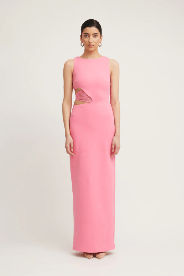 Valentina Dress Rouge Pink by Tojhà – A bold and sleek maxi with a boat neckline and unique waist cut-out, perfect for elegant evenings and special events.
