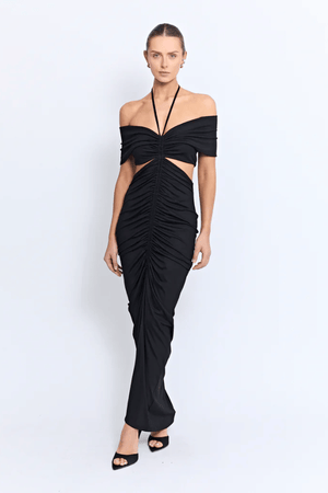 Angello Maxi Dress Black by Pfeiffer – A sleek off-shoulder maxi with cut-outs, front ruching, and an open back, perfect for formal evenings, special events, or statement celebrations.
