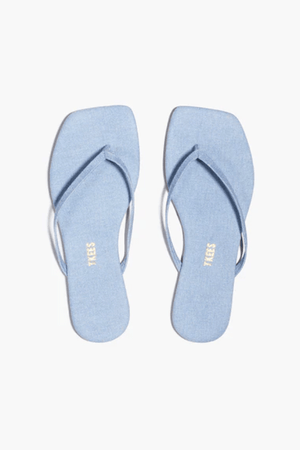 Square Toe Lily Washed Denim by Tkees, a square-toe slide sandal in soft washed denim with a cushioned denim insole and rubber outsole. Handcrafted in Brazil for comfort and style.