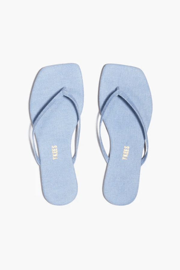Square Toe Lily Washed Denim by Tkees, a square-toe slide sandal in soft washed denim with a cushioned denim insole and rubber outsole. Handcrafted in Brazil for comfort and style.