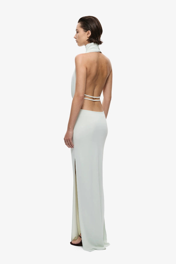 The Cowl Neck Jersey Dress by MISHA, halter cowl maxi with open back and side split for sleek evening styling.