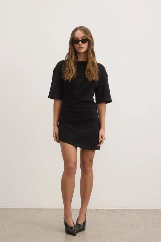 Joanna Dress in Black by Bayse, a relaxed cotton t-shirt dress with dropped shoulders and modern asymmetric hemline.