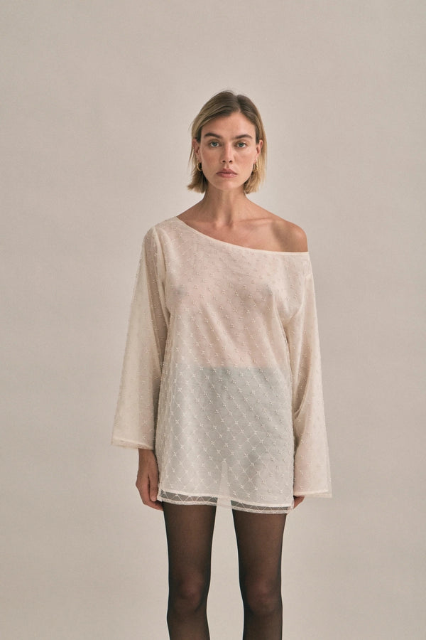 The Eloise Beaded Mini Ivory by Solaqua – sheer beaded mini dress with off shoulder neckline and oversized fit.