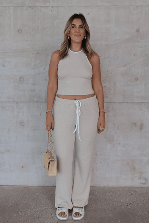 Charlie Pant Sand/White by Sneaky Link, trendy and comfortable low-rise pants with elastic waist and contrast drawcord, perfect for chic summer days and evenings.