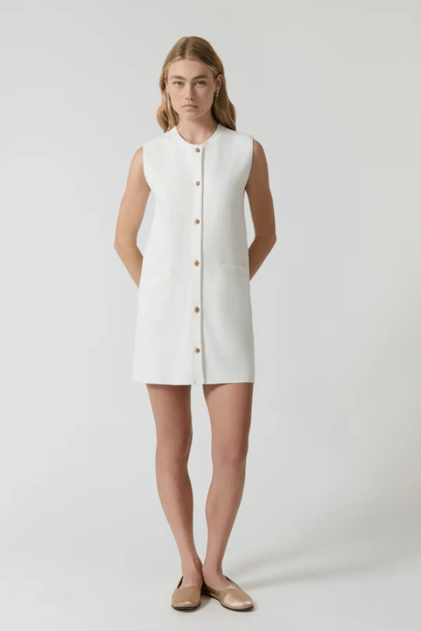 Nanda Dress White by Onte – A chic, timeless sleeveless mini shift in heavy Milano knit with gold knot buttons and welt pockets, perfect for effortless day-to-night style.