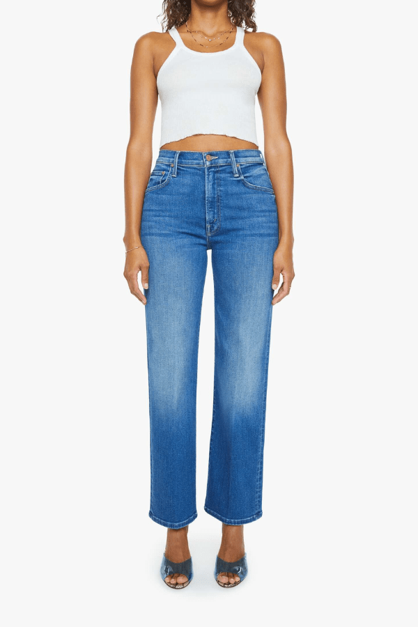 The Rambler Zip Flood Nip In The Bud by MOTHER, trendy high-rise jeans with a wide straight leg and cropped, clean hem. Perfect for a laid-back, polished look in mid-blue with subtle fading and whiskering.