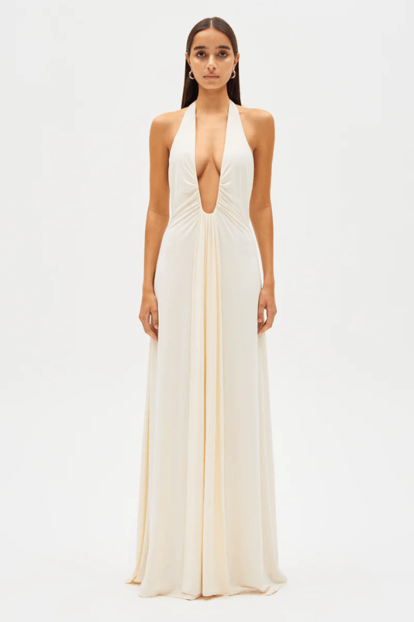 Jennifer Cupro Maxi Dress Ivory by Misha – A sleek and sophisticated maxi with a plunging halter neckline and dramatic sash, perfect for elegant day-to-night events.