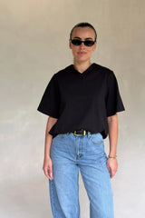 Black Olivia High V Neck Relaxed Tee with short sleeves and a loose fit on a plain background.