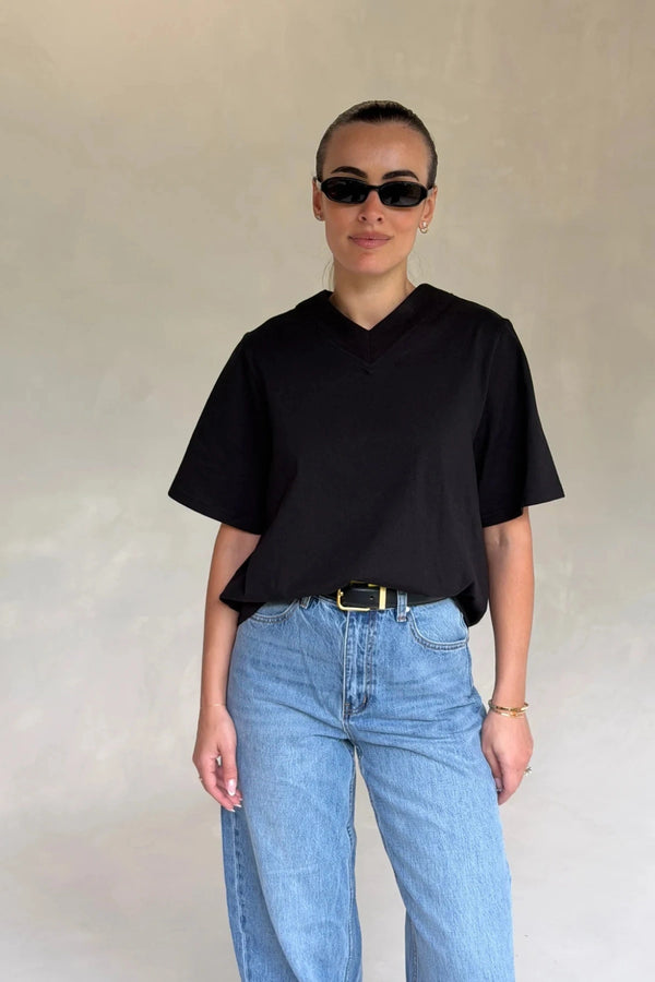 Black Olivia High V Neck Relaxed Tee with short sleeves and a loose fit on a plain background.