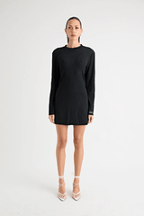Fairbank Rib Dress Black by Pfeiffer – A trendy, comfortable ribbed bamboo dress with high raw-edge neckline, full sleeves, and versatile two-part back design. Perfect for chic casual wear or layering in cooler seasons.