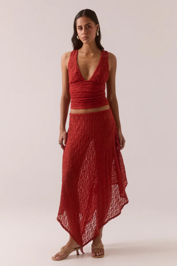 Aaila Lace Skirt – Blood Orange by Sovere, stretch lace midi with asymmetric hem and removable lining. Perfect for elevated looks.