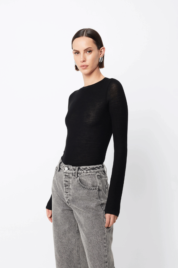 Maine Long Sleeve Top Black by Mossman – A viral, lightweight Merino wool essential with a sleek round neck and body-skimming fit, perfect for year-round layering or solo wear.