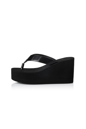 Lulu Sandal by Alias Mae, a bold black leather wedge with 9cm lift and clean silhouette. Perfect for elevated everyday or evening wear.
