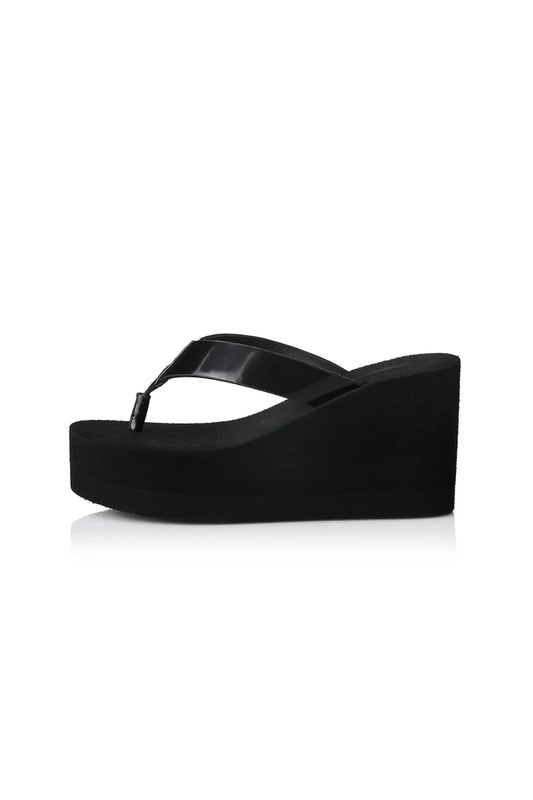 Lulu Sandal by Alias Mae, a bold black leather wedge with 9cm lift and clean silhouette. Perfect for elevated everyday or evening wear.