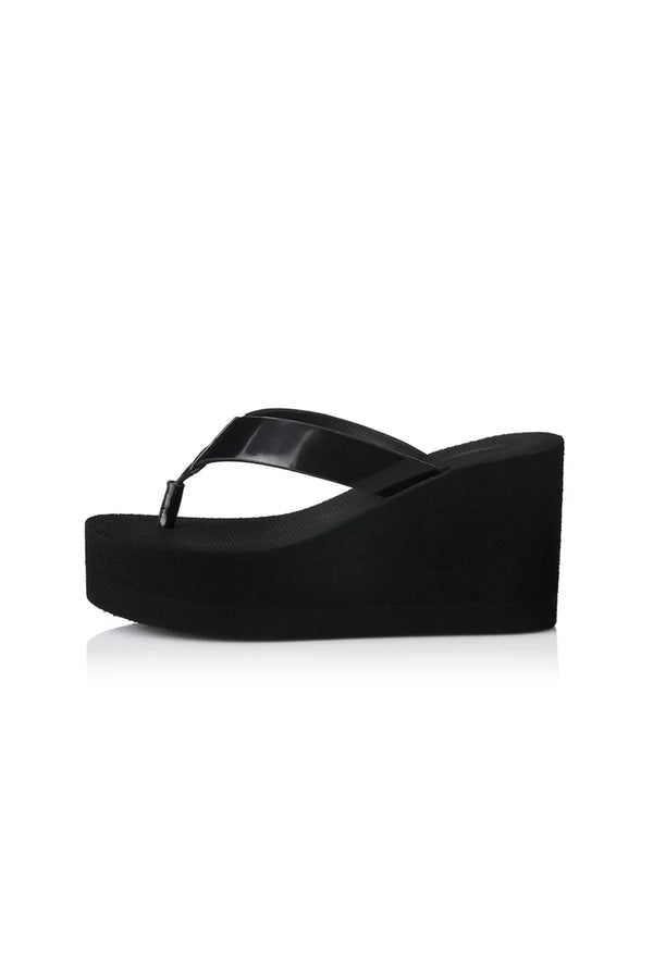 Lulu Sandal by Alias Mae, a bold black leather wedge with 9cm lift and clean silhouette. Perfect for elevated everyday or evening wear.