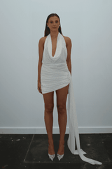 Tiffany Dress Ivory Glitter by DŽO – Trendy rhinestone-embellished sheer mesh mini with cowl neckline, ruched skirt, and dramatic side train, perfect for glamorous evening statement occasions.