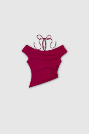 Flor Top Magenta by The Wolf Gang — an elegant event-ready top with asymmetric neckline, soft jersey fabric, and delicate beaded strap. True to size, perfect for casual or bold looks.