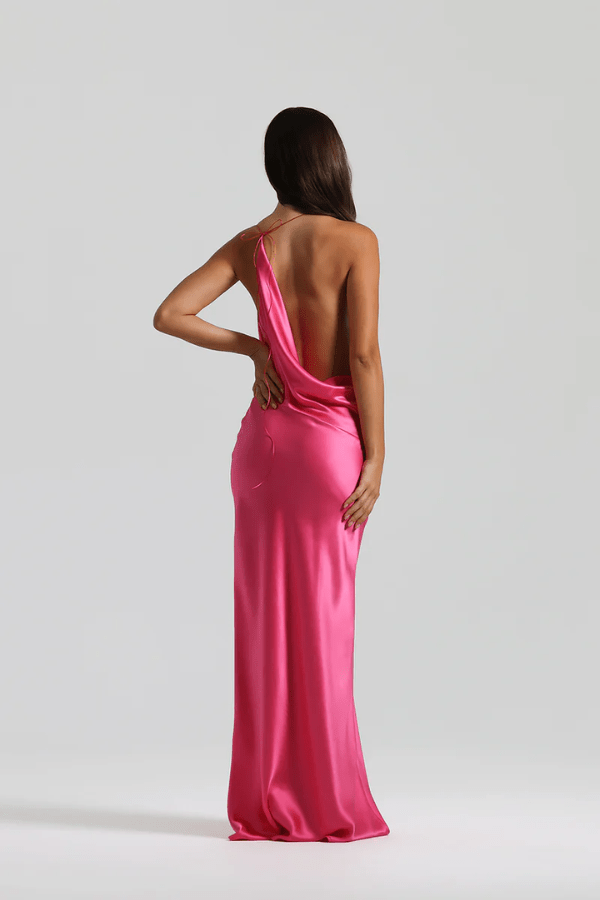 Gabi Gown Neon Pink by Natalie Rolt – A vibrant, bias-cut silk gown with dramatic open back and adjustable ties, perfect for making a trendy statement at special events.