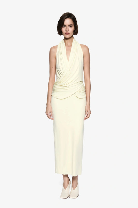The Cabana Cupro Dress by MISHA, a lemon midi with halter neckline and soft hip drape. Perfect for weddings or refined summer events.