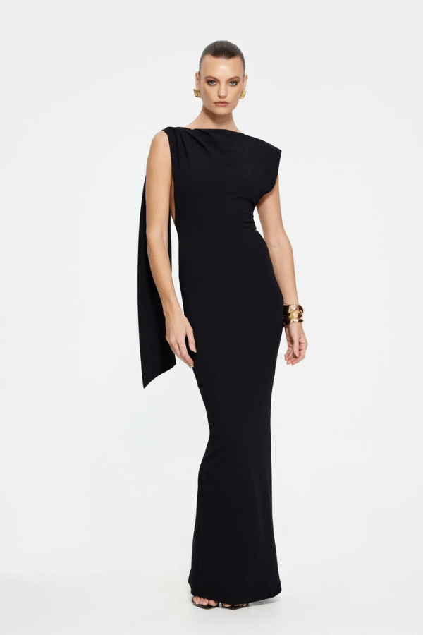 Audrey Gown Black by Effie Kats – A stretch-crepe gown with a straight neckline and dramatic low back, perfect for black-tie affairs, red carpet moments, or elegant evening events.