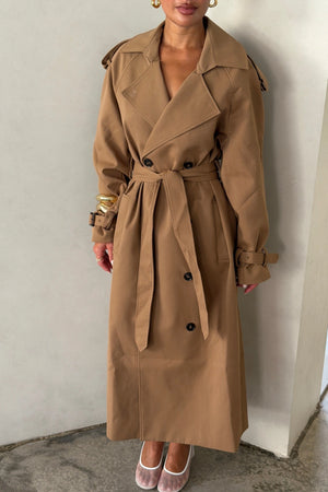Trench Coat Tan by Sneaky Link – A timeless oversized coat in rich tan polyester, featuring classic details and subtle snake embroidery. Perfect for stylish transitional days.