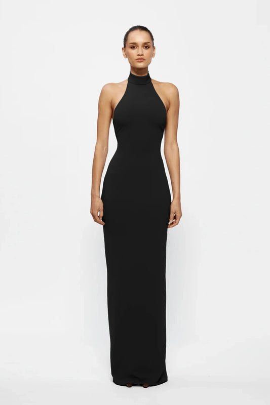 Rhi Gown in Black by Effie Kats, floor-length stretch crepe gown with open back and high neckline. Perfect for formal events and special evenings.