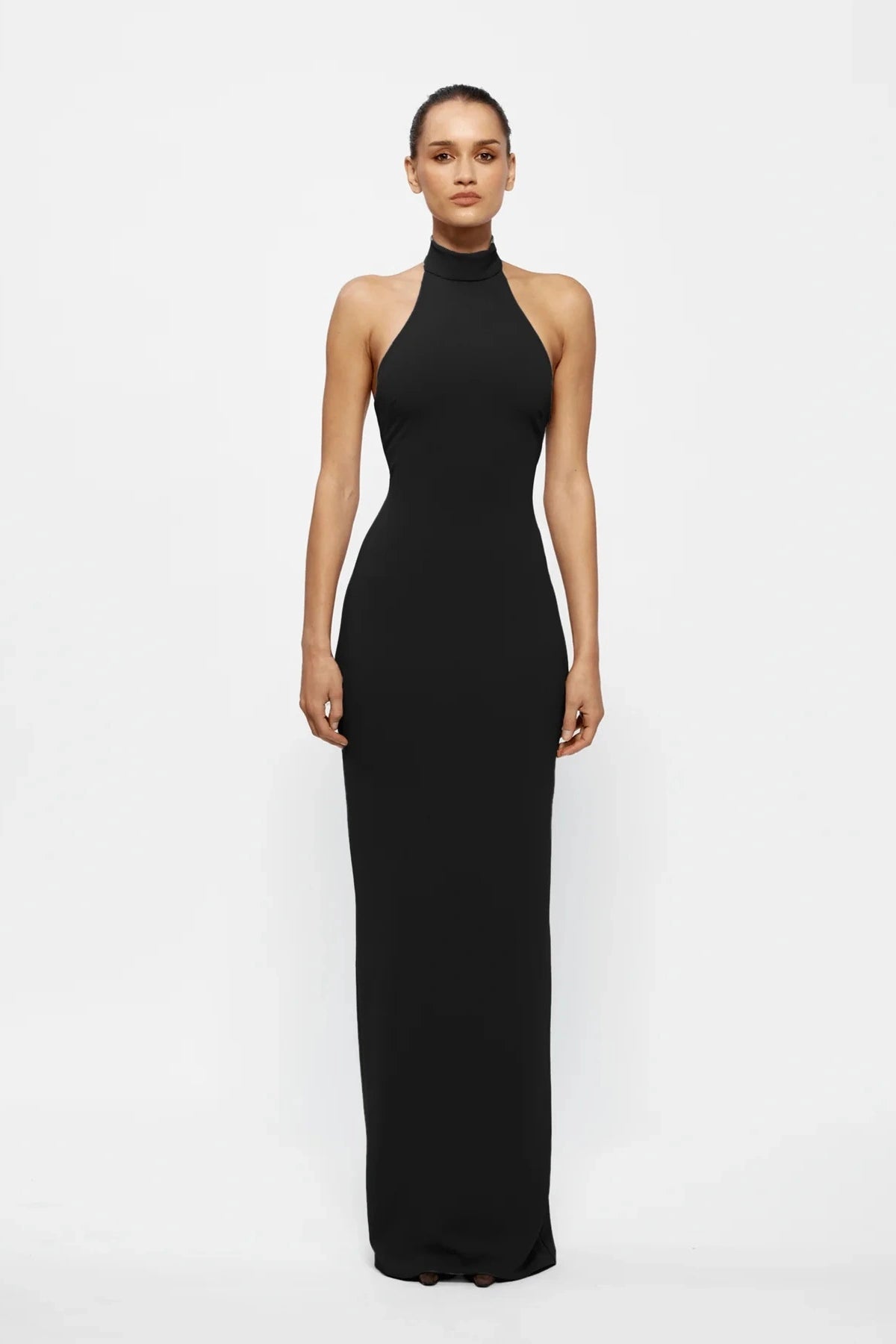 Rhi Gown in Black by Effie Kats, floor-length stretch crepe gown with open back and high neckline. Perfect for formal events and special evenings.