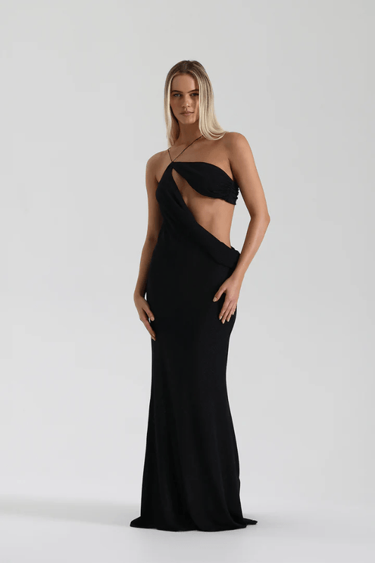 Elissa Dress Black by Natalie Rolt – A glamorous stretch-knit maxi with metallic threads, asymmetrical cutaway, and adjustable fit, perfect for elegant evenings and special occasions.
