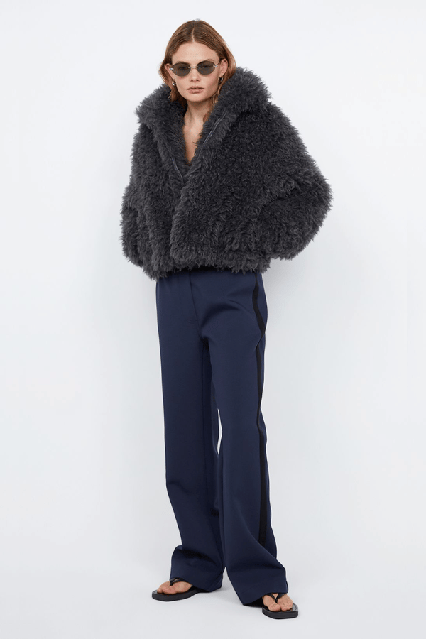 Argo Jacket Charcoal by Bec + Bridge – A chic charcoal faux fur bomber with wide collar, relaxed fit, front hook closure, and low waist finish. Fully lined. Dry clean only.