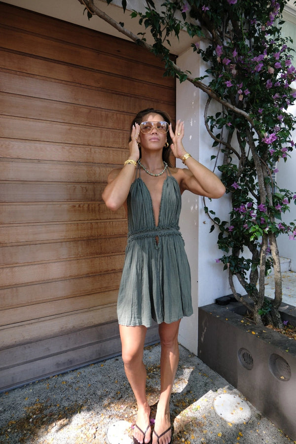 Lefkothea Mini Dress Khaki by D'Artemide – One-size cotton mini with halter tie, deep V neckline, low back, and side cutouts.