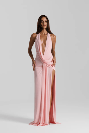 Winona Gown Blossom Pink by Natalie Rolt, elongated halter neckline, asymmetric draped bust overlay, open back, exaggerated side split, gathered waterfall skirt, full-length hem, elevated jersey. Dry clean only.