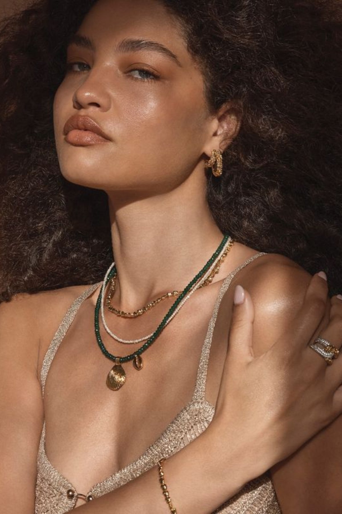 Lucca Earrings by Amber Sceats – handcrafted in Italy with 24K gold-plated brass, featuring a curved silhouette for timeless elegance.
