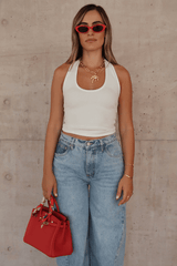 Bella Halter Tank White by Sneaky Link – Soft cotton-spandex blend with a deep scoop neckline, open back, and supportive halter design. Perfect for layering or solo wear.