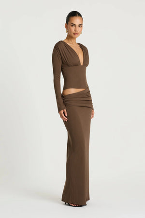 Agnes Maxi Dress in Chocolate by Benni, a ribbed long-sleeve maxi with deep plunge neckline, gathered bust, and subtle hip draping.