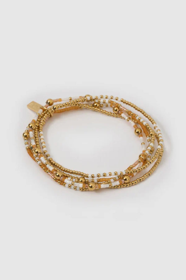 Nellie Bracelet Mango by Arms of Eve, vibrant beaded design with mango, white, and gold tones adding playful colour and chic sophistication.