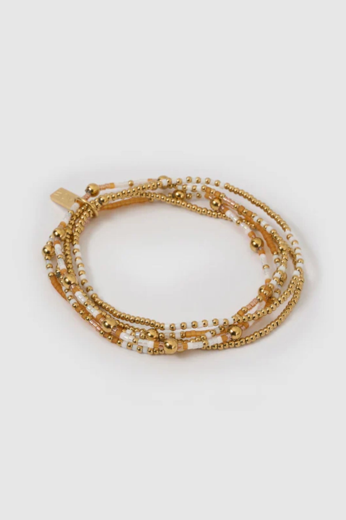 Nellie Bracelet Mango by Arms of Eve, vibrant beaded design with mango, white, and gold tones adding playful colour and chic sophistication.