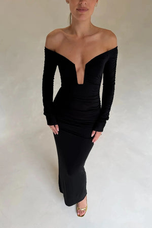 Black Haley off-shoulder midi dress with fitted bodice and flowy skirt, featuring short sleeves and a subtle slit.