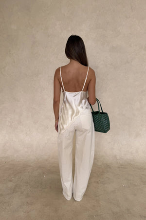 Lilah Lace Trim Top Ivory by Sneaky Link – an asymmetrical top with lace trim and V neckline. Perfect for elevated day-to-night looks.