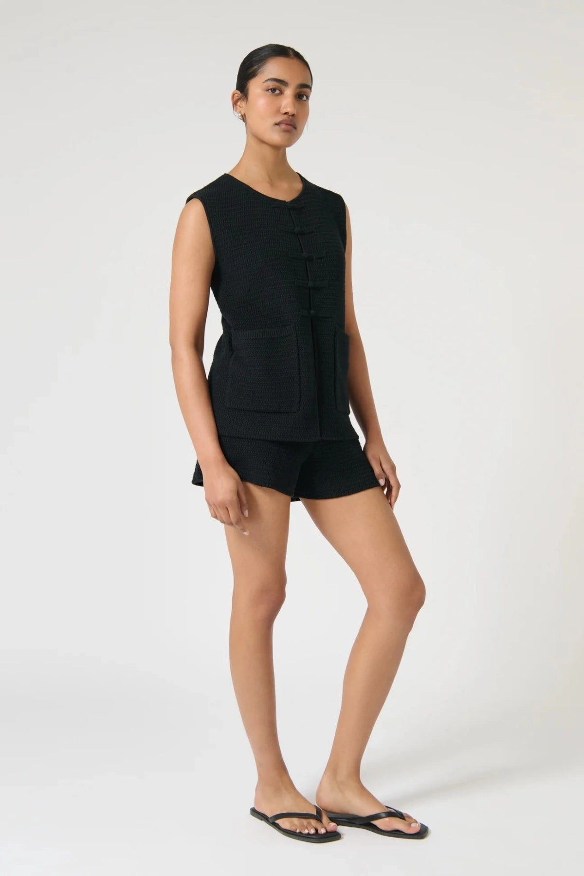 Onte Helena Shorts in black cotton crochet knit with elastic waistband, mini fit, styled with matching Helena Gilet.