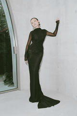 Monaco Gown Black by Effie Kats – Elegant soft mesh gown with high neckline, long sleeves, and daring open back, featuring ruching and crossed waist for a sculpted, timeless silhouette.