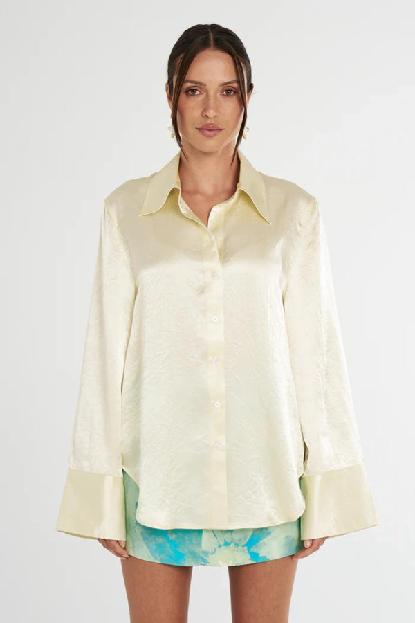 Cuff Shirt Butter by Summi Summi, soft butter-hued shirt with a structured collar and oversized flared cuffs. Lightweight acetate fabric for effortless sophistication.