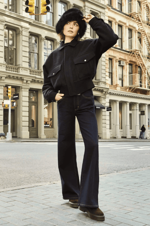 Eva Wide Cannes Dark Indigo by Neuw Denim, trendy tailored wide-leg jeans with a fitted mid-rise waist and A-line cut. Perfect for a feminine, laid-back look in dark indigo denim with subtle fading and contrast tobacco stitching.