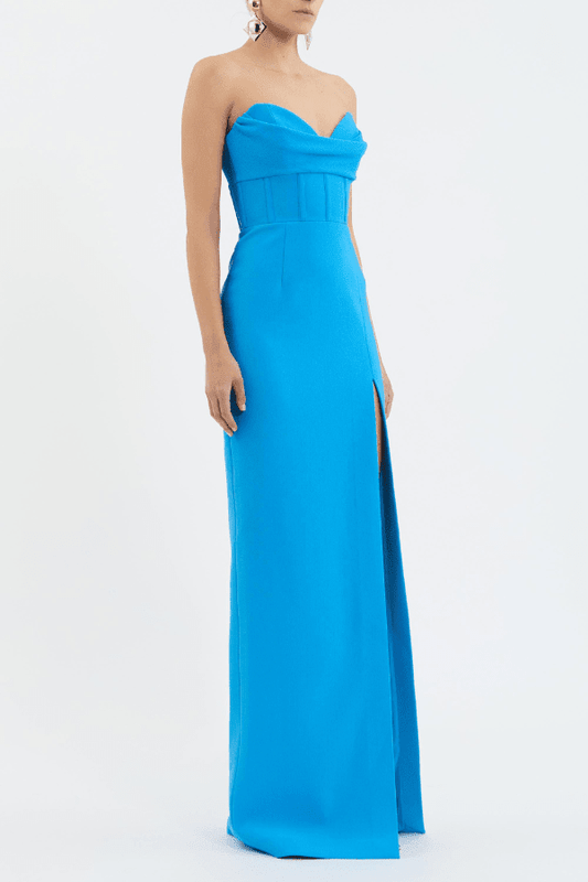 Skyla Gown Bright Blue by Rebecca Vallance – Viral strapless sweetheart gown with corseted waist and front slit, combining elegance and allure for standout formal occasions.