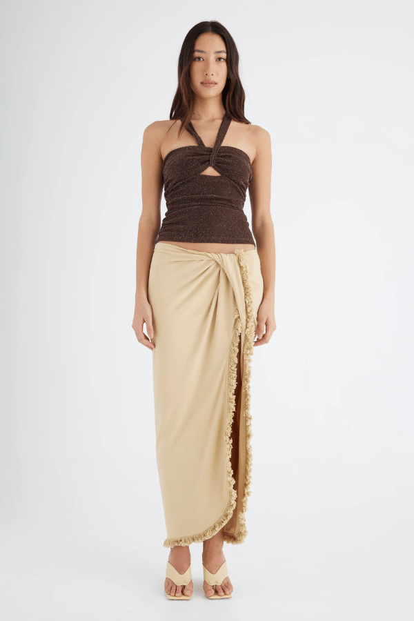 Bernie Fringe Skirt Butter by Benni — Midi skirt with mid-rise waist, front knot, side split, and fringe trim. Made from soft, comfortable jersey fabric.